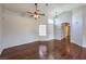Spacious living room with hardwood floors, high ceilings, a ceiling fan, and abundant natural light at 4357 Valley Regal Way, North Las Vegas, NV 89032