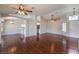 Spacious living room with wood floors, a ceiling fan, and arched doorways at 4357 Valley Regal Way, North Las Vegas, NV 89032