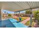 Covered patio area with a brick-paved section and a lawn in the backyard at 4357 Valley Regal Way, North Las Vegas, NV 89032