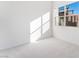 Well-lit bedroom featuring a large window and wall-to-wall carpet at 655 Spotted Falcon St, Las Vegas, NV 89138