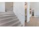 Modern staircase with carpeted steps and neutral wall colors at 655 Spotted Falcon St, Las Vegas, NV 89138