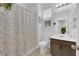 Bright bathroom featuring a vanity, toilet, and shower with a colorful polka dot curtain at 734 Last Dance Pl, Henderson, NV 89011