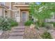 Inviting front entrance with stone steps, rock landscaping, and cozy front porch at 734 Last Dance Pl, Henderson, NV 89011