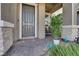 Charming front porch with a gray front door, stone accents, and decorative plants at 734 Last Dance Pl, Henderson, NV 89011