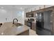 Bright kitchen featuring granite counters, stainless steel appliances, and dark cabinetry at 734 Last Dance Pl, Henderson, NV 89011