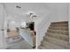 Open living room with staircase and view to the kitchen and dining area at 734 Last Dance Pl, Henderson, NV 89011