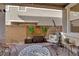 Cozy outdoor patio with decorative rug, hanging chair, and stylish seating, perfect for relaxation at 734 Last Dance Pl, Henderson, NV 89011