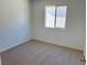 Well-lit bedroom with neutral carpeting and window at 1029 Ferodale Ave, North Las Vegas, NV 89084