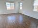 Spacious living room with wood-look tile flooring and large windows at 1029 Ferodale Ave, North Las Vegas, NV 89084