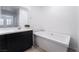 Bathroom with free-standing tub and dark brown vanity at 2555 Hampton Rd # 4308, Henderson, NV 89052