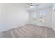 Bright bedroom with ceiling fan, carpet, and arched windows at 2555 Hampton Rd # 4308, Henderson, NV 89052