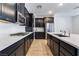 Modern kitchen with dark cabinetry, quartz countertops and stainless steel appliances at 2555 Hampton Rd # 4308, Henderson, NV 89052