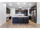 Modern kitchen with island, stainless steel appliances, and dark cabinetry at 2555 Hampton Rd # 4308, Henderson, NV 89052