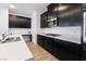Modern kitchen with dark cabinets, a large island, and stainless steel appliances at 2555 Hampton Rd # 4308, Henderson, NV 89052