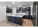 Modern kitchen with dark cabinetry, quartz countertops, and stainless steel appliances at 2555 Hampton Rd # 4308, Henderson, NV 89052