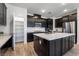 Spacious kitchen featuring dark cabinetry, ample counter space, and a large island at 2555 Hampton Rd # 4308, Henderson, NV 89052