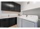 Laundry room with dark cabinets, washer, and dryer at 2555 Hampton Rd # 4308, Henderson, NV 89052