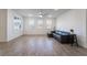 Living room with wood-look floors, large windows, and a ceiling fan at 2555 Hampton Rd # 4308, Henderson, NV 89052