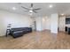 Spacious living room with hardwood floors, ceiling fan, and view into kitchen at 2555 Hampton Rd # 4308, Henderson, NV 89052