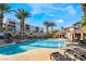 Community pool with lounge chairs and palm trees at 2555 Hampton Rd # 4308, Henderson, NV 89052