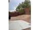 This backyard features brick retaining walls, landscaping, and a concrete patio at 256 Camino Viejo St, Henderson, NV 89012