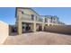 Property featuring a spacious, dirt-filled backyard with block wall fencing and a covered patio area at 657 N Water St, Henderson, NV 89015