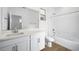 Bright bathroom featuring a single sink vanity and a tub at 657 N Water St, Henderson, NV 89015
