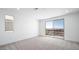 Bright bedroom with neutral carpet, recessed lighting, and a sliding door to a balcony with city views at 657 N Water St, Henderson, NV 89015