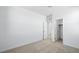 Well-lit bedroom showcases neutral carpeting, an open doorway to an adjoining room, and a closet door at 657 N Water St, Henderson, NV 89015