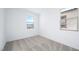 A bedroom with two windows and neutral carpet at 657 N Water St, Henderson, NV 89015