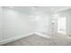Bright hallway featuring neutral carpet, white walls and banister, and recessed lighting at 657 N Water St, Henderson, NV 89015