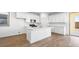 Well-lit kitchen with white cabinets, stainless steel appliances, and access to the backyard at 657 N Water St, Henderson, NV 89015