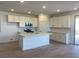 Modern kitchen featuring white cabinets, an island, and tile backsplash at 657 N Water St, Henderson, NV 89015