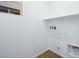 A bright laundry room features wood look tile and white walls at 657 N Water St, Henderson, NV 89015