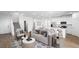 Bright, open living room flows into a modern kitchen with stainless steel appliances and a breakfast bar at 657 N Water St, Henderson, NV 89015