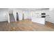 Open-concept living space with staircase, hardwood floors, flowing into a bright kitchen at 657 N Water St, Henderson, NV 89015