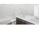 Well-lit bathroom featuring a dual sink vanity and a shower over tub at 655 N Water St, Henderson, NV 89015