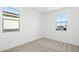 This is a bedroom with neutral walls and carpet and two windows at 655 N Water St, Henderson, NV 89015