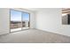 This is a bedroom with neutral walls and carpet and a sliding glass door to the balcony at 655 N Water St, Henderson, NV 89015