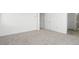 This is a bedroom with neutral walls and carpet and doors leading to the bathroom and closet at 655 N Water St, Henderson, NV 89015