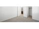 This is a bedroom with neutral walls and carpet and doors leading to the bathroom and closet at 655 N Water St, Henderson, NV 89015