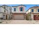 Inviting home featuring a stone-accented two-car garage and neutral stucco exterior, framed by desert landscaping at 655 N Water St, Henderson, NV 89015