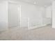 Hallway with white walls and carpet, plus a white wooden railing at 655 N Water St, Henderson, NV 89015