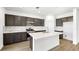 Modern kitchen boasts stainless steel appliances, white countertops, and an island with a sink and breakfast bar at 655 N Water St, Henderson, NV 89015