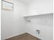 Laundry room with tile floor, white walls, and shelving at 655 N Water St, Henderson, NV 89015