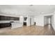 Open-concept living space connects seamlessly to the kitchen, highlighted by wood-look tile flooring throughout at 655 N Water St, Henderson, NV 89015