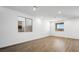 Bright and airy living room featuring wood-look tile flooring and multiple windows for natural light at 655 N Water St, Henderson, NV 89015