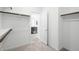 Walk-in closet with white walls and rods for hanging clothes at 655 N Water St, Henderson, NV 89015