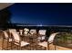 Outdoor patio with dining set and stunning city views at night at 1492 Macdonald Ranch Dr, Henderson, NV 89012