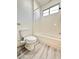 Cozy bathroom featuring a combination shower and tub with white subway tile and wood-look floor at 6745 Keren Marie Ave, Las Vegas, NV 89110